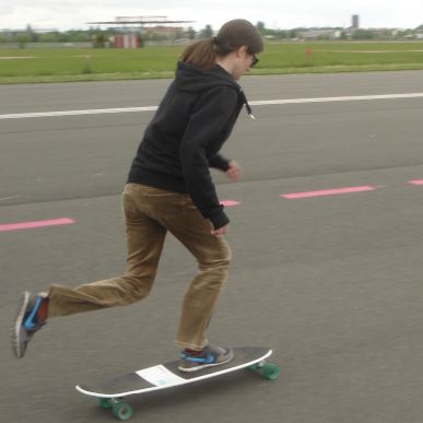 Katja skateboarding on an airport runway